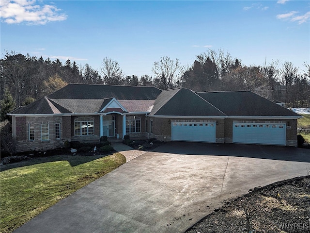 single story home with driveway, a front yard, and a garage