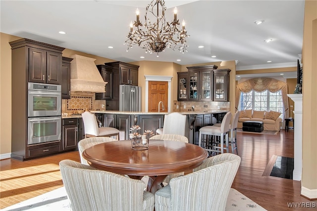 dining area featuring recessed lighting, baseboards, light wood-style floors, and a fireplace