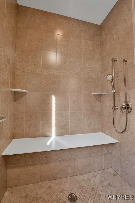 bathroom with a tile shower