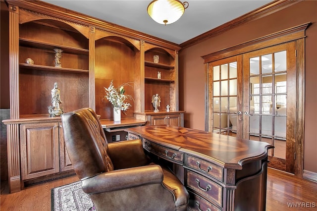 office space with wood finished floors, french doors, and ornamental molding