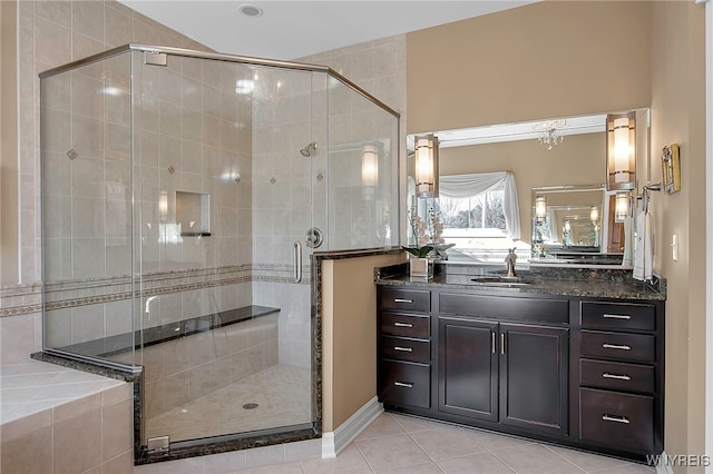 bathroom featuring tile patterned floors, a stall shower, and vanity