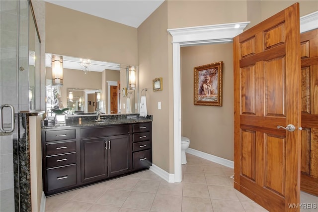 full bathroom with baseboards, toilet, a stall shower, tile patterned floors, and vanity