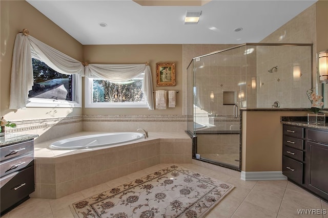 full bath featuring tile patterned floors, a stall shower, a bath, and vanity