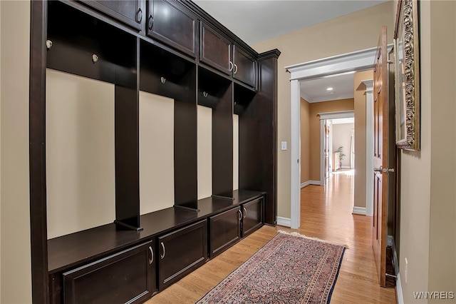 mudroom featuring baseboards and light wood finished floors