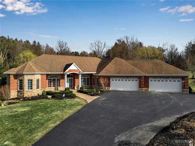 ranch-style home with a front lawn, aphalt driveway, stone siding, roof with shingles, and a garage