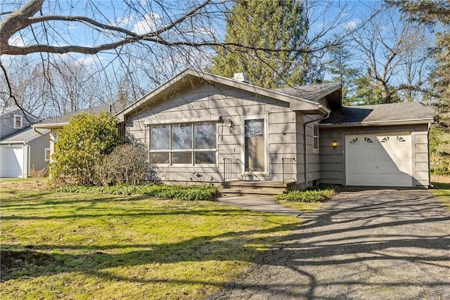 view of front of home with a front yard, an attached garage, and driveway