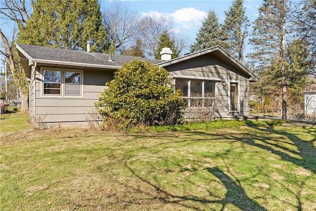 view of front of property with a front yard and a chimney