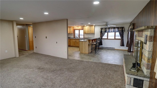 kitchen with recessed lighting, a kitchen breakfast bar, light carpet, and visible vents