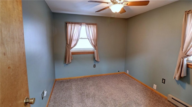 spare room featuring baseboard heating, baseboards, carpet, and a ceiling fan