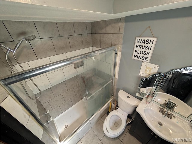 full bathroom with a sink, toilet, a shower stall, and tile patterned flooring