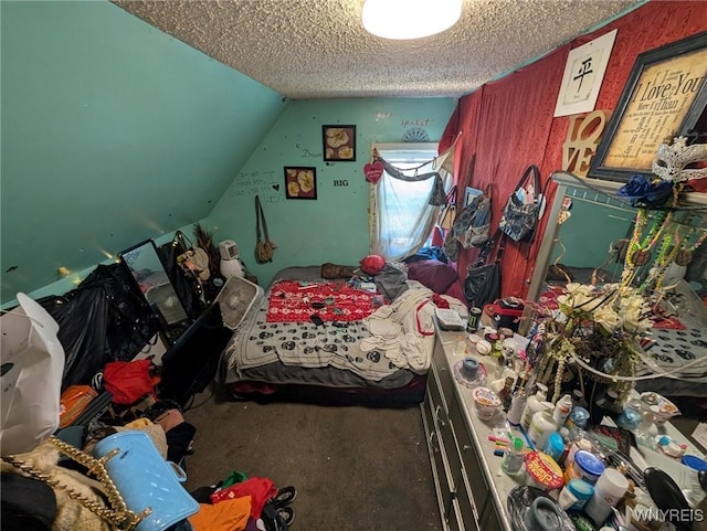 bedroom with a textured ceiling and vaulted ceiling