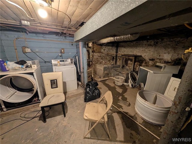 unfinished below grade area featuring separate washer and dryer