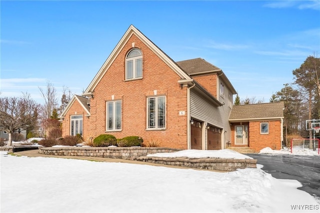 view of front of house with brick siding and an attached garage