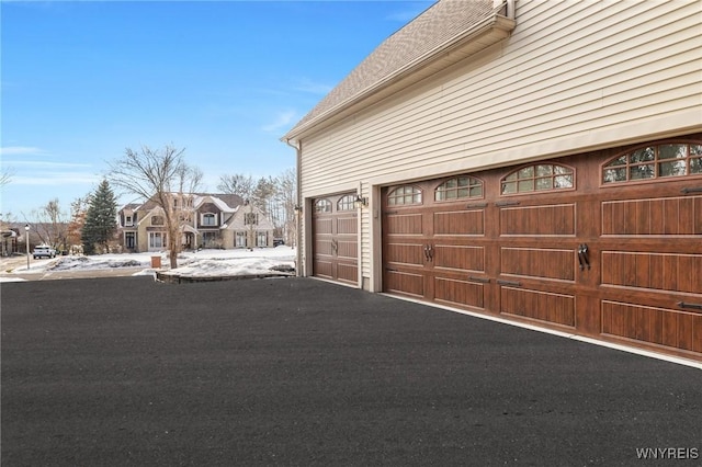 garage with a residential view and driveway