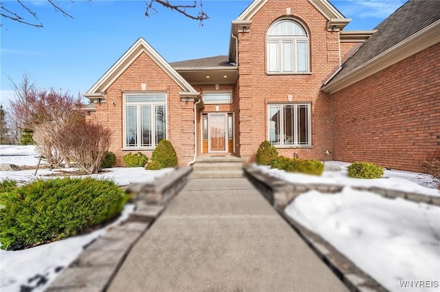 doorway to property with brick siding