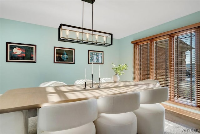 dining area with an inviting chandelier and wood finished floors