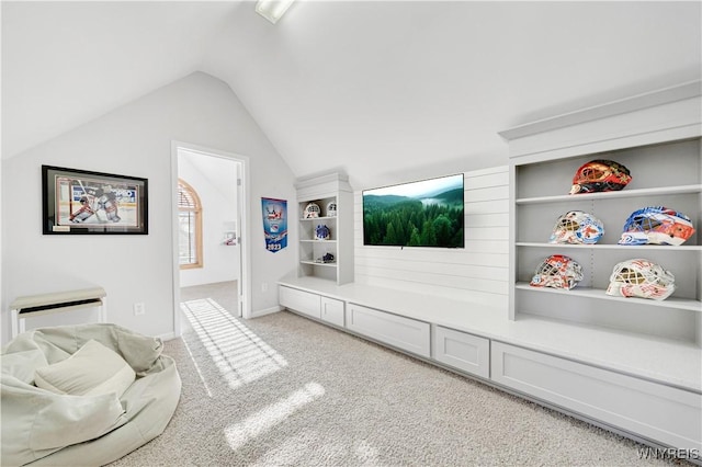 interior space featuring lofted ceiling and light carpet