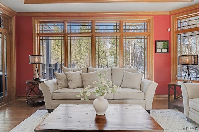 living room with crown molding, baseboards, and dark wood-style flooring