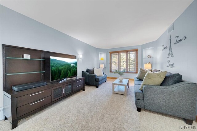 living room with light colored carpet, visible vents, and baseboards