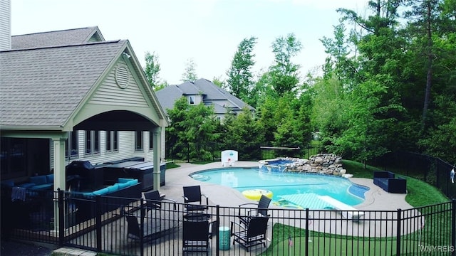 view of swimming pool featuring a patio area, fence, and a pool with connected hot tub