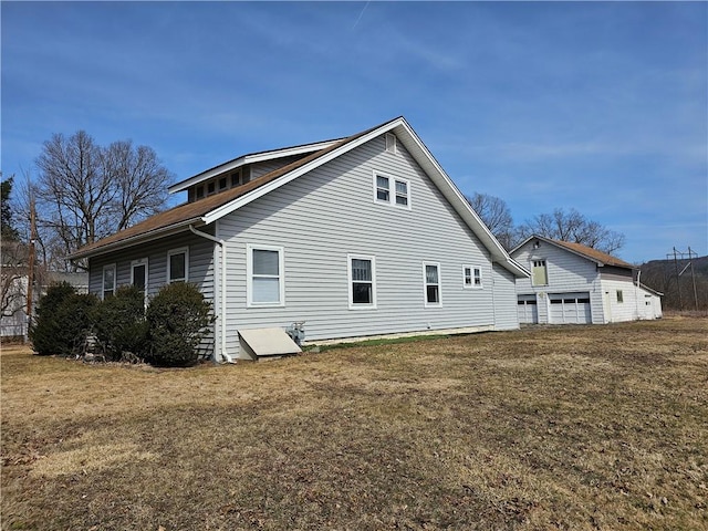 back of property featuring a yard