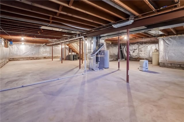 unfinished basement with heating unit and water heater