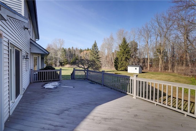 deck featuring a storage shed, a lawn, and an outdoor structure