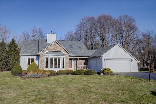 view of front of property featuring a front lawn, driveway, covered porch, a garage, and a chimney