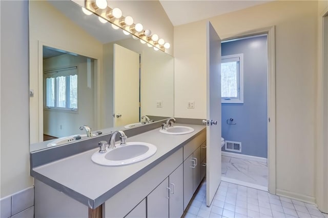 bathroom featuring toilet, visible vents, and a sink