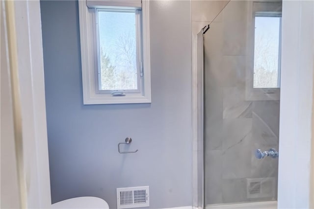 full bathroom featuring visible vents, toilet, and a stall shower