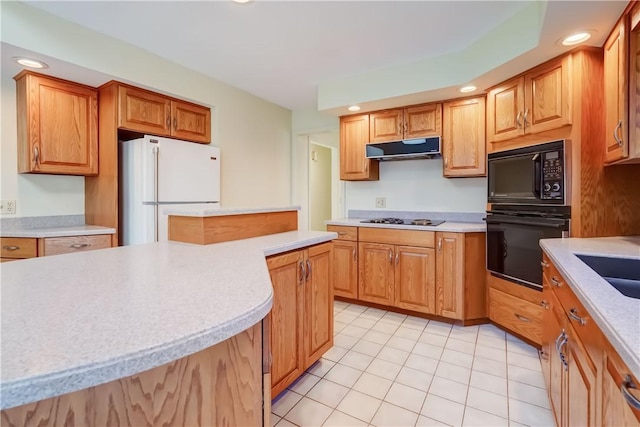 kitchen with black appliances, recessed lighting, extractor fan, and light countertops