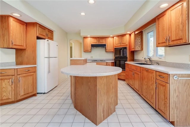 kitchen featuring black appliances, under cabinet range hood, a sink, a center island, and light countertops