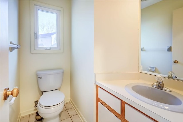 bathroom featuring vanity, tile patterned floors, toilet, and baseboards