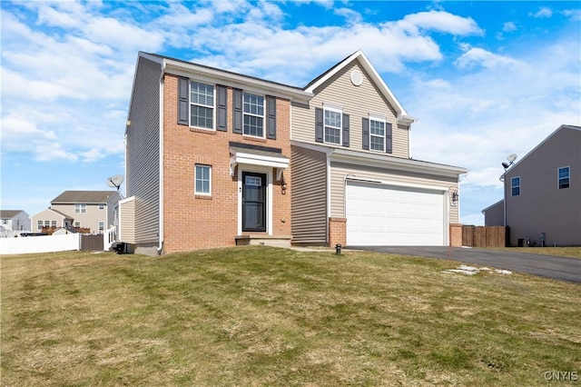 traditional-style house with brick siding, a front lawn, fence, aphalt driveway, and a garage