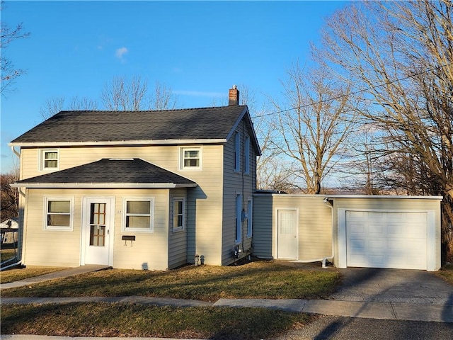 view of front of house with driveway, roof with shingles, a chimney, a front lawn, and a garage