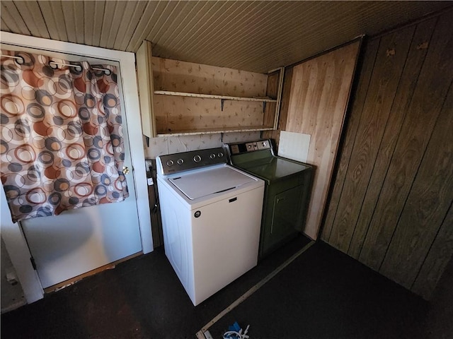 laundry area featuring washer / dryer, wooden ceiling, wood walls, and laundry area