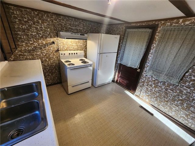 kitchen with visible vents, a sink, ventilation hood, white appliances, and light floors