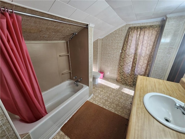 bathroom featuring toilet, vanity, lofted ceiling, and shower / bathtub combination with curtain