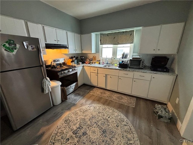 kitchen with a sink, white cabinets, under cabinet range hood, and stainless steel appliances