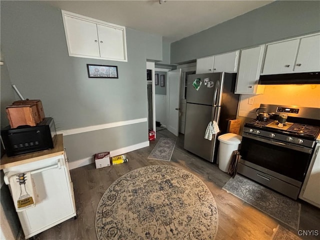 kitchen featuring white cabinetry, under cabinet range hood, wood finished floors, and appliances with stainless steel finishes