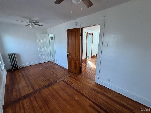 unfurnished room featuring hardwood / wood-style flooring, radiator heating unit, baseboards, and ceiling fan