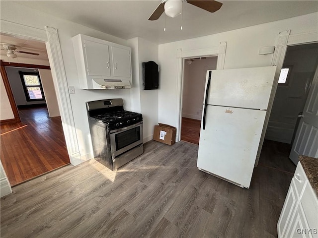 kitchen with white cabinetry, freestanding refrigerator, dark wood-style flooring, and stainless steel gas range