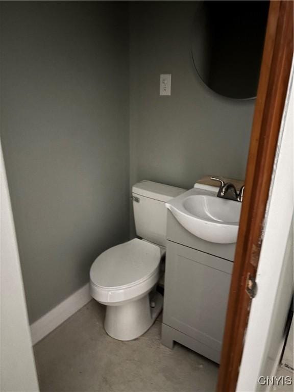 bathroom featuring vanity, toilet, and baseboards