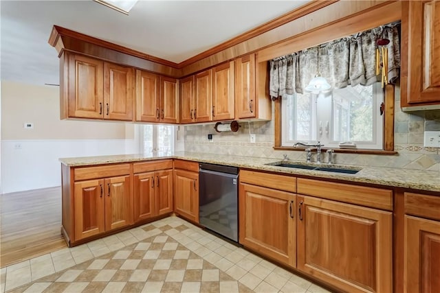 kitchen featuring dishwashing machine, light stone counters, brown cabinetry, a peninsula, and a sink