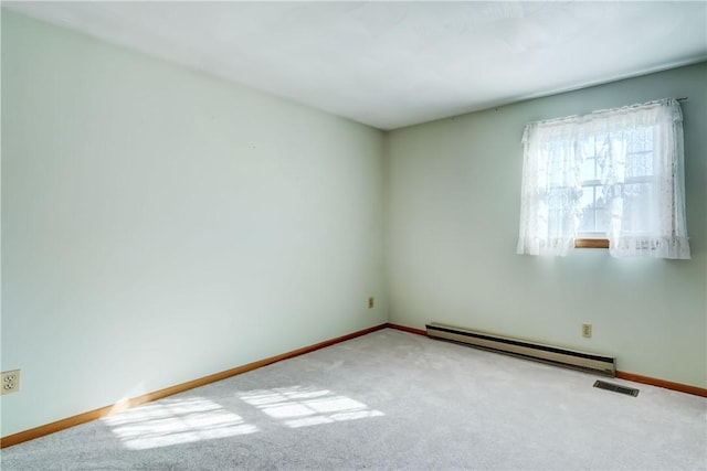 carpeted empty room featuring a baseboard heating unit, baseboards, and visible vents