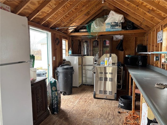 interior space with washer / dryer, vaulted ceiling, and freestanding refrigerator