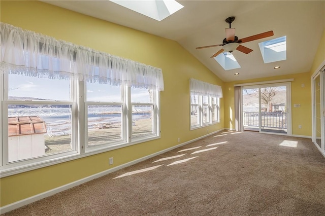 interior space with recessed lighting, baseboards, lofted ceiling with skylight, and a ceiling fan