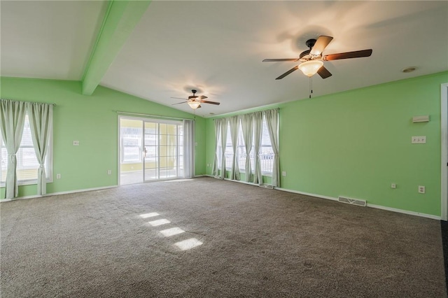 carpeted spare room featuring plenty of natural light, baseboards, visible vents, and vaulted ceiling with beams