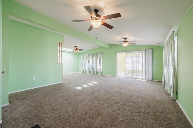 carpeted empty room featuring ceiling fan, vaulted ceiling with beams, and baseboards