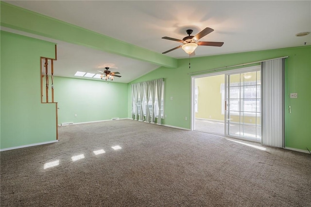 spare room with visible vents, carpet floors, baseboards, ceiling fan, and vaulted ceiling with beams